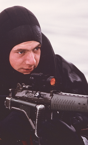A man is aiming with a gun