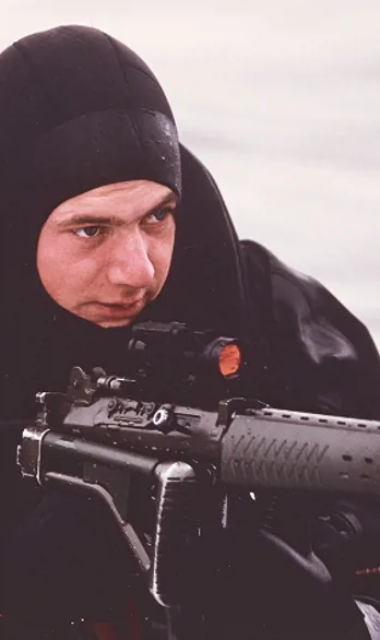 A man is aiming with a gun